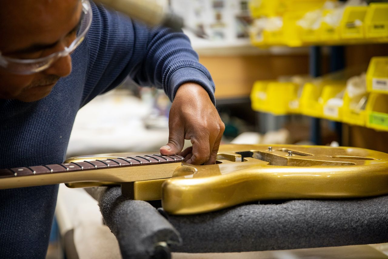 A technician works on a guitar at Fender's Mod Shop