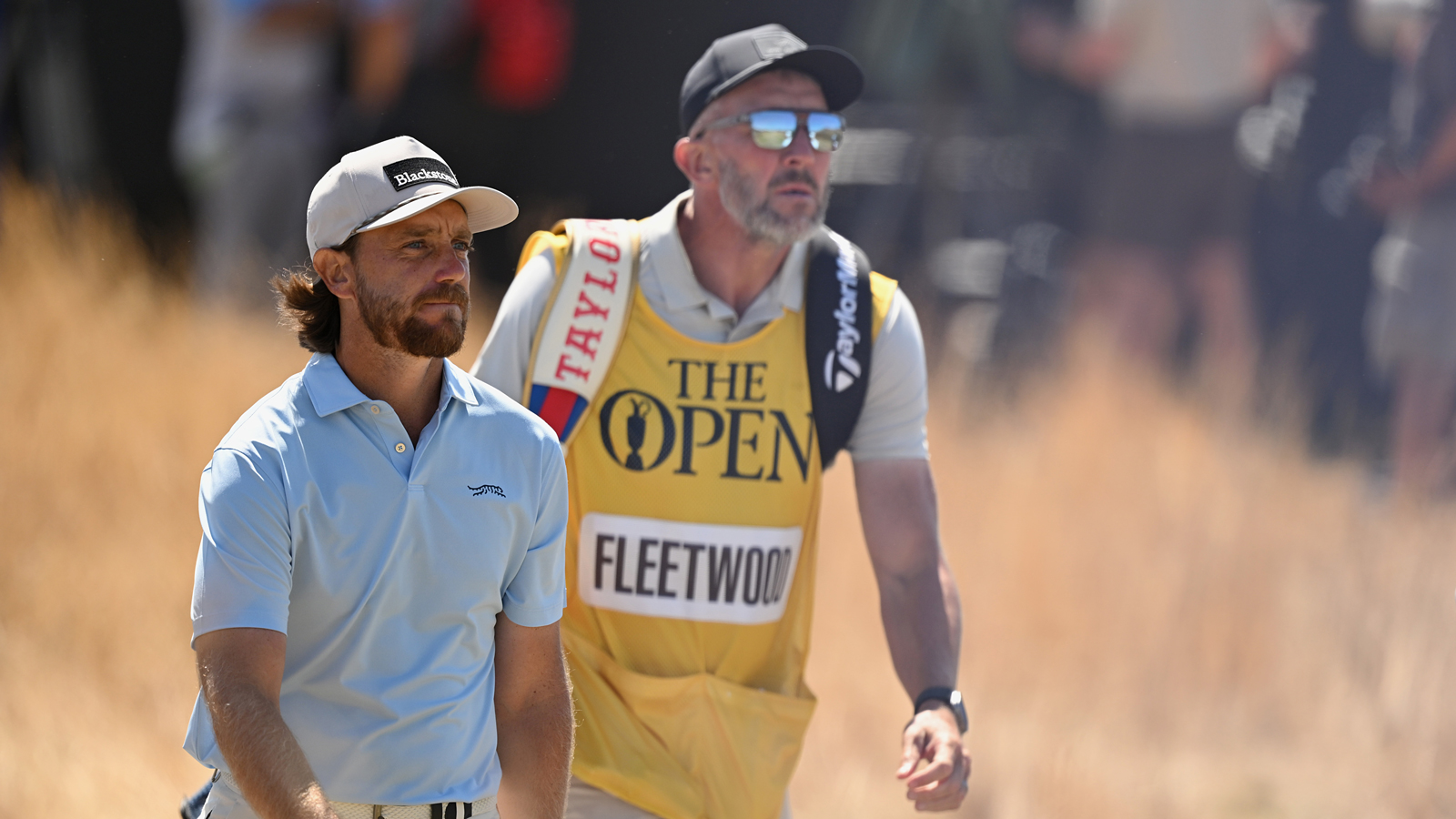 Tommy Fleetwood and his caddie walk down the fairway