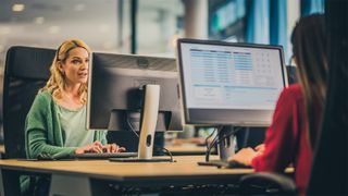 women working on computers in sales office