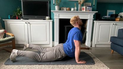 Fit & Well fitness writer Harry Bullmore completing a mobility routine at home