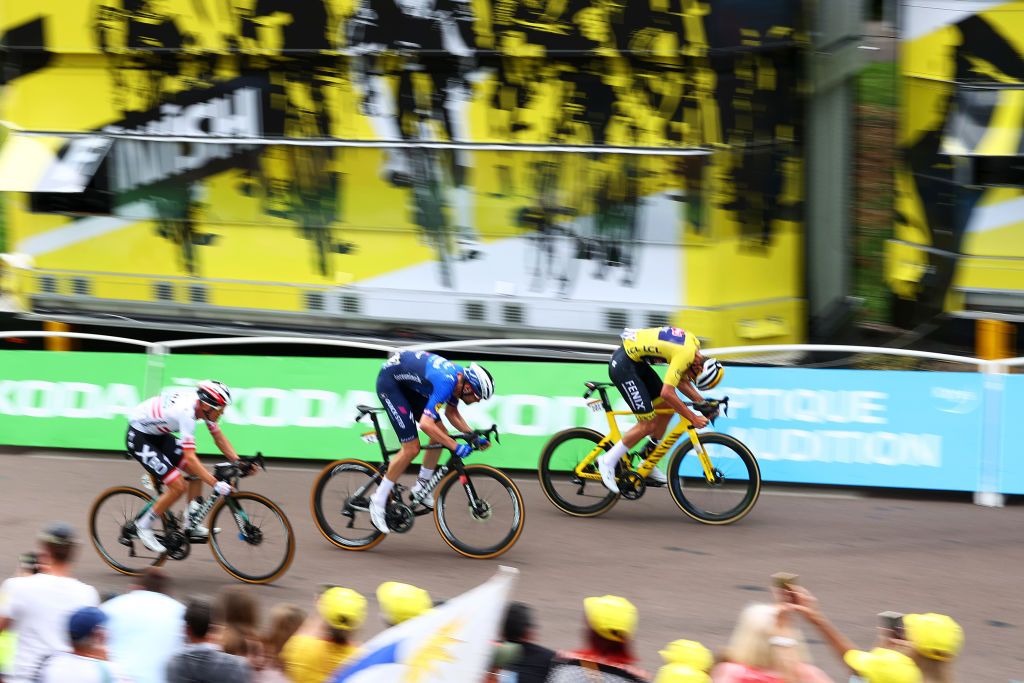LE CREUSOT FRANCE JULY 02 Mathieu Van Der Poel of The Netherlands and Team AlpecinFenix yellow leader jersey Kasper Asgreen of Denmark and Team Deceuninck QuickStep Patrick Konrad of Austria and Team BORA Hansgrohe at arrival during the 108th Tour de France 2021 Stage 7 a 2491km km stage from Vierzon to Le Creusot 369m Landscape LeTour TDF2021 on July 02 2021 in Le Creusot France Photo by Michael SteeleGetty Images