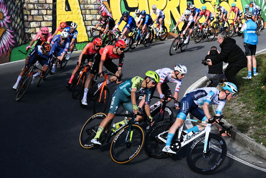 UAE Team Emirates' Slovenian rider Tadej Pogacar (2nd R) and Bahrain Victorious's Slovenian rider Matej Mohoric (R) ride through the Cipressa during the 115th Milan-SanRemo one-day classic cycling race, between Pavia and SanRemo, on March 16, 2024. (Photo by Marco BERTORELLO / AFP)