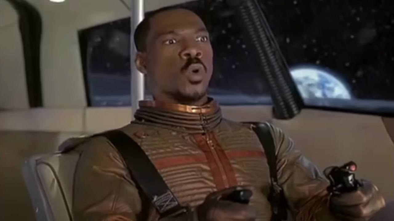 Eddie Murphy looks worried while driving a moon vehicle in The Adventures of Pluto Nash.