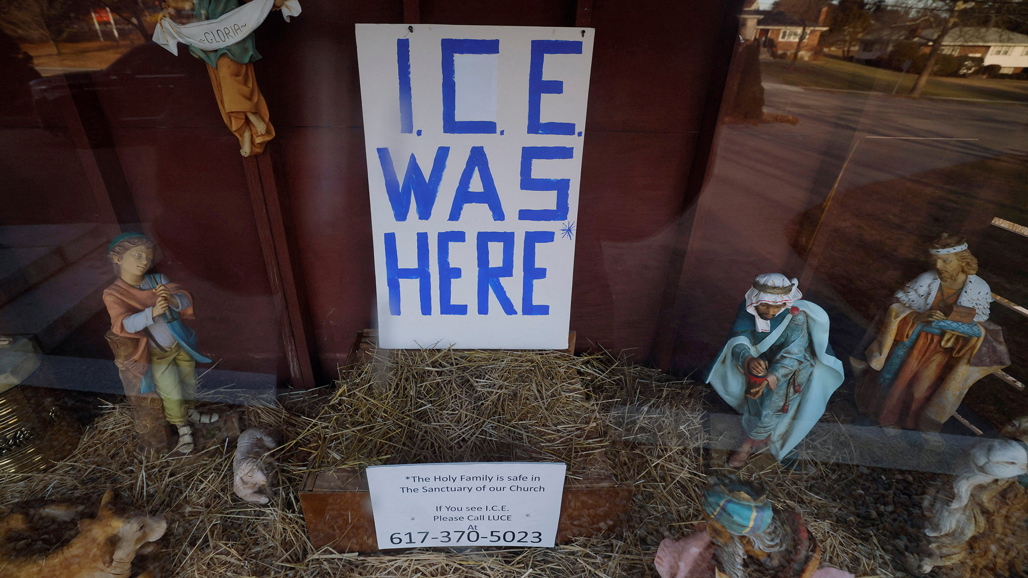 A sign reading &quot;ICE Was Here&quot; stands in a Nativity Scene, with the figures of the Virgin Mary and St. Joseph missing, in Dedham, USA