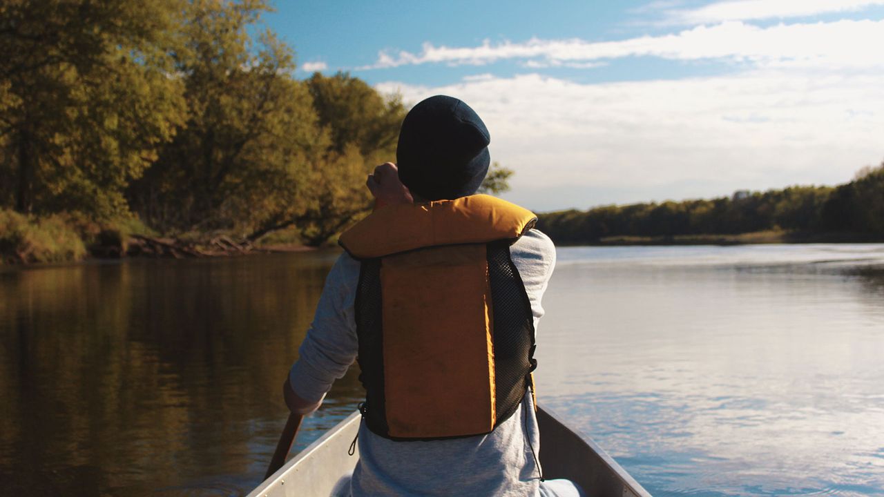 Person paddling while wearing a life jacket