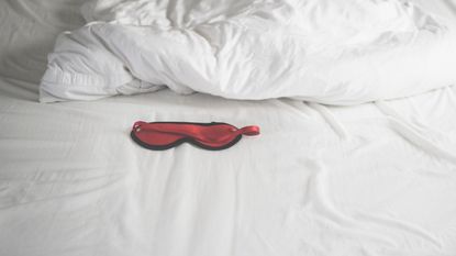 red eye mask on bed 