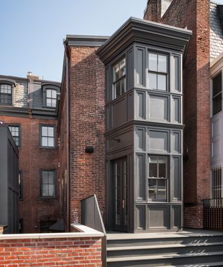 house exterior with redbrick and gray windows