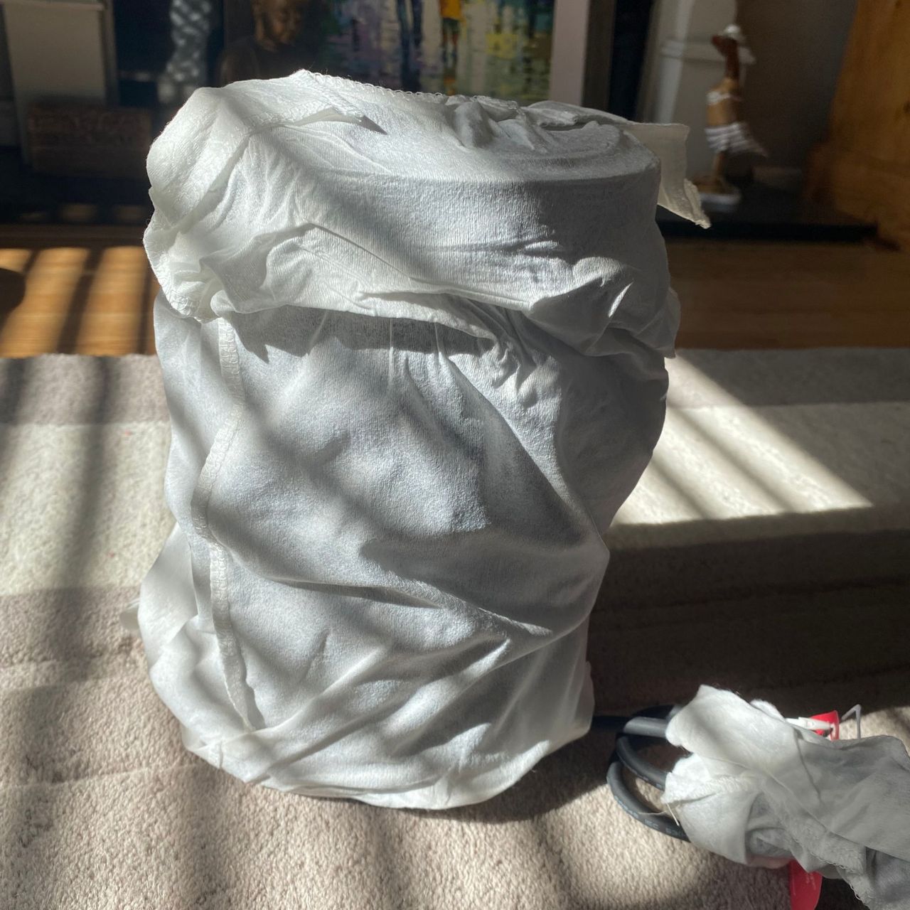 Morphy Richards HeatFlux 1.5kW Ceramic Fan Heater wrapped in a fabric dustbag on a neutral rug