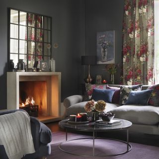 contemporary stone fireplace in grey living room with dark floral curtains