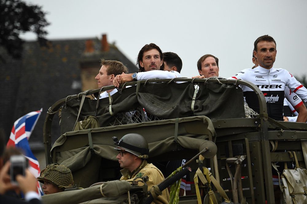 Riders of the USA's Trek - Segafredo cycling team, including Switzerland's Fabian Cancellara (C), take part in a parade aboard an World War II US army jeep during the team presentation