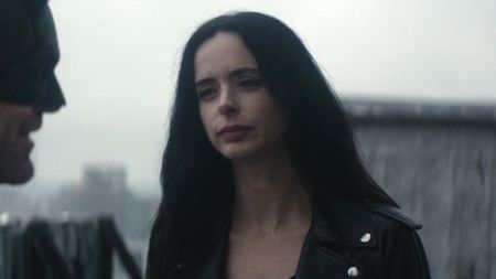 Jessica Jones looking mad while speaking to Daredevil on a roof in Born Again.