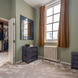 bedroom with black cabinet and mirror on wall