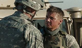 The Hurt Locker Jeremy Renner speaking with a fellow soldier in front of a Hummer