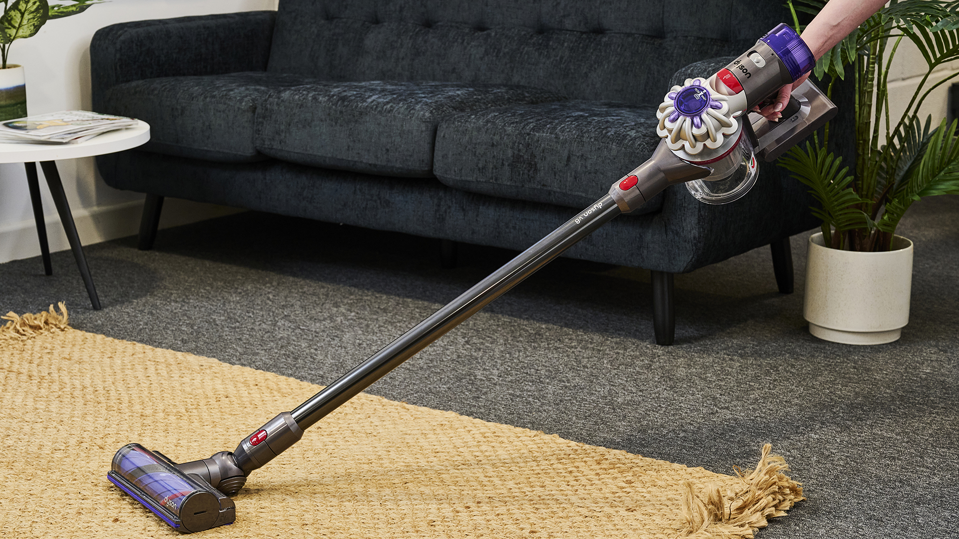 Person using Dyson V8 vacuum