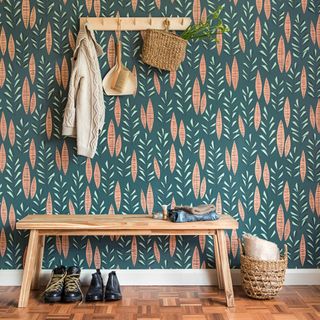 hallway decor wall ideas, retro print wallpaper, scandi style bench and peg rail, wood floor, shoes, basket, cardigan hanging from peg rail and dustpan and brush
