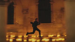 Tom Cruise runs through a candlelit church in Mission:Impossible - Dead Reckoning Part One.