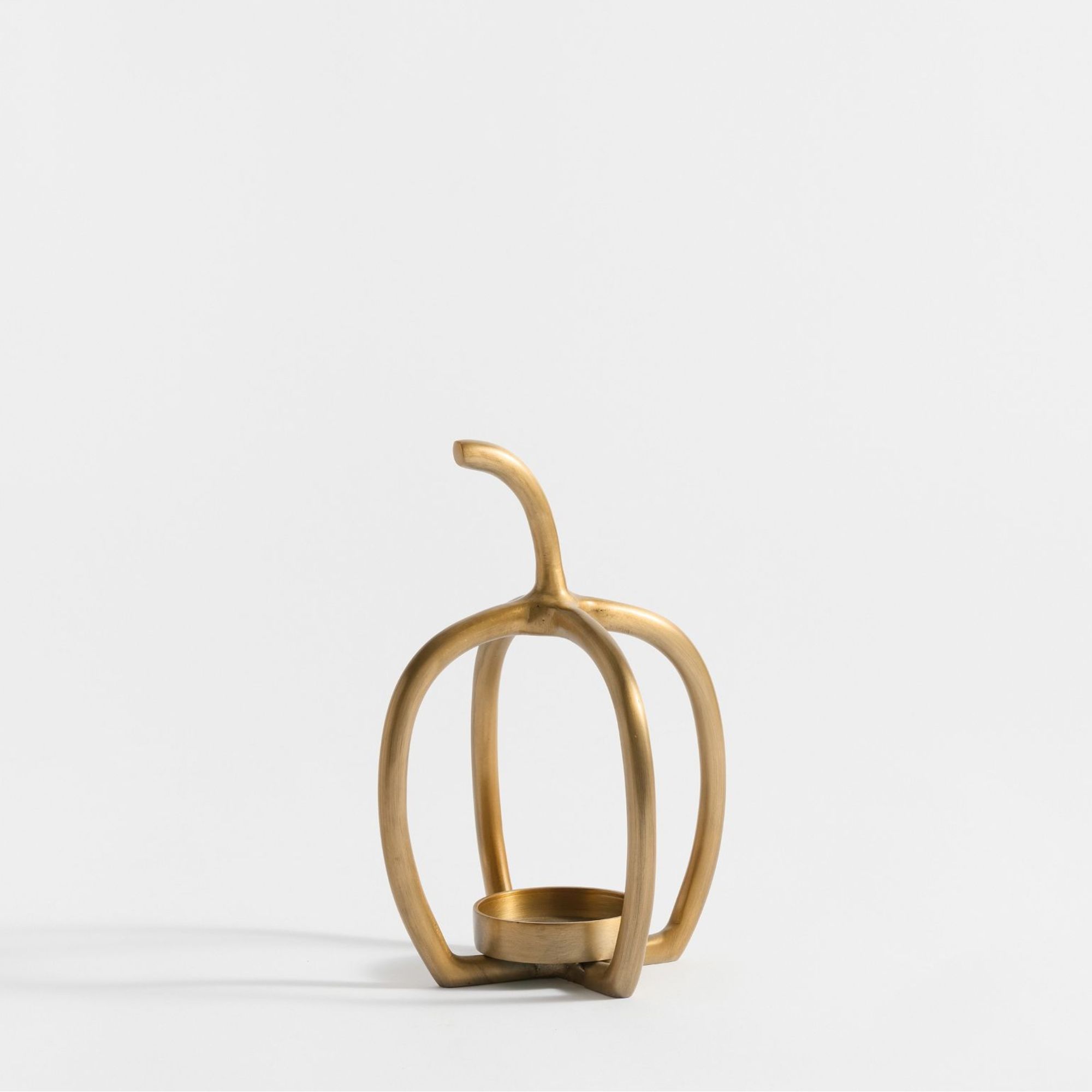 Brass votive candle holder in pumpkin shape