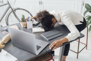 Insomnia treatment: Tired freelancer sleeping on her desk