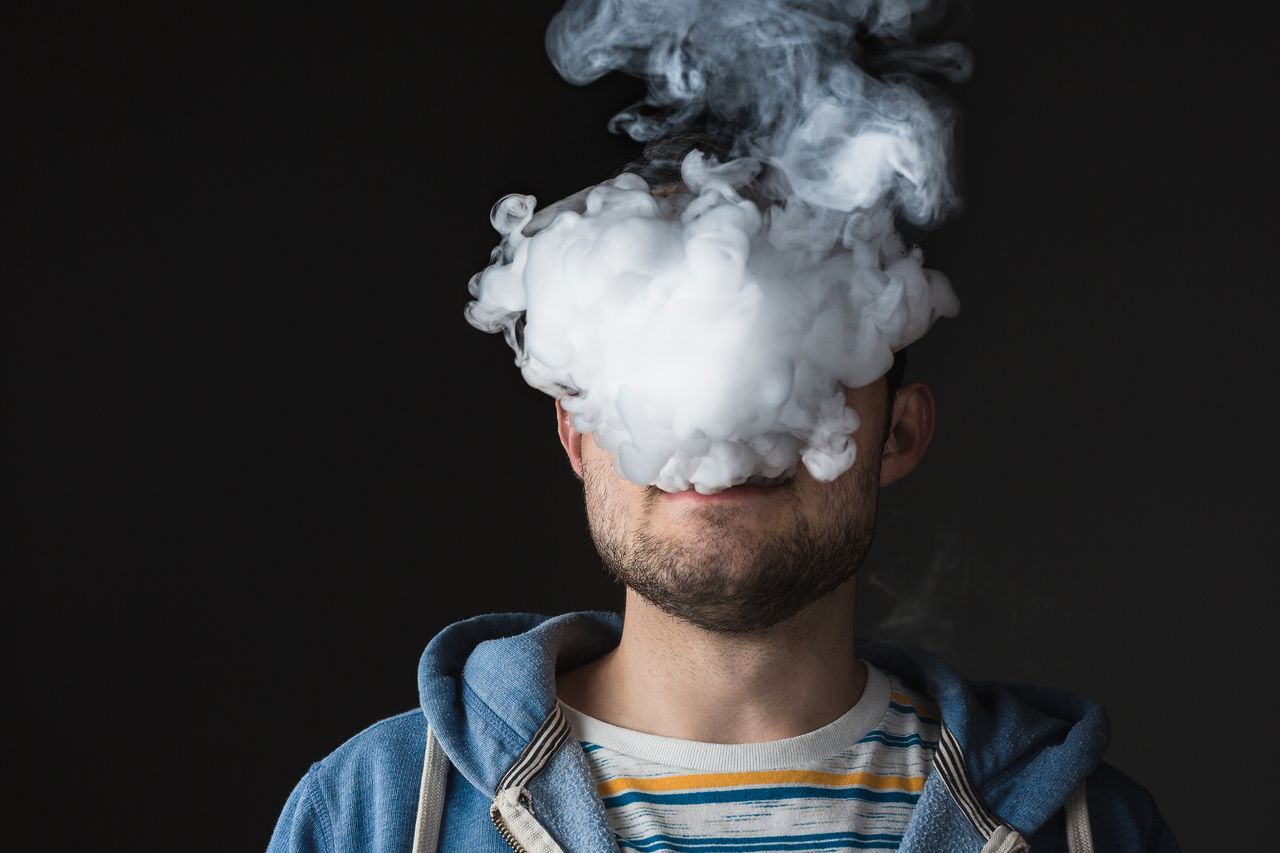 Young man vaping.