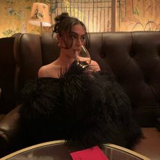 Woman drinking wine in a cocktail lounge