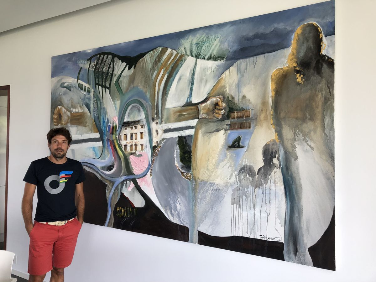 Oscar Freire shows off artwork around his house. In this piece the shadows on the left represent his family. You can also see the rainbow stripes, while above the pink section is the hotel he and the Spanish team stayed at. To the right of that is the final corner where Freire attacked in Verona.