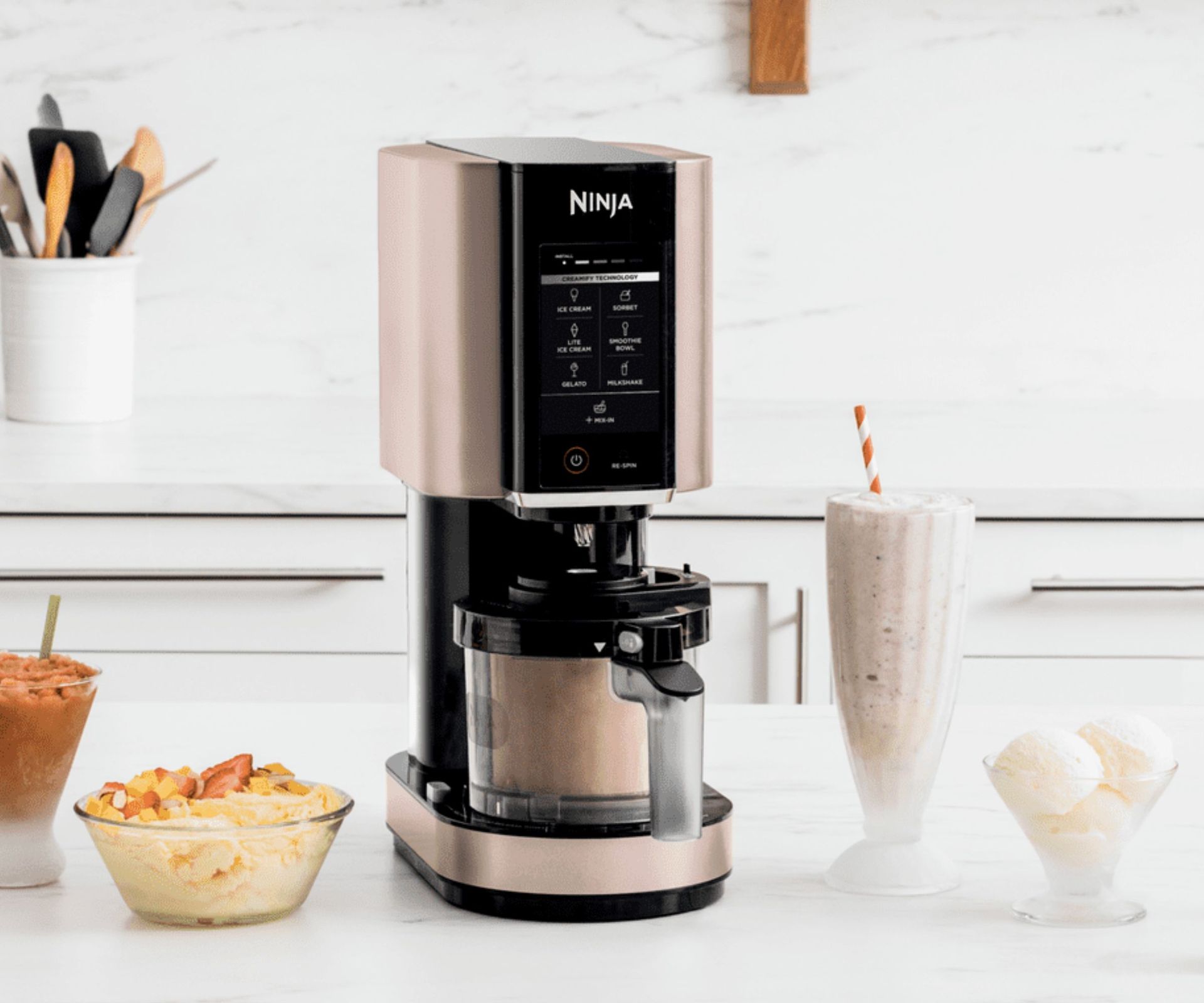 Ninja Creami ice cream maker with ice cream and milkshakes nearby