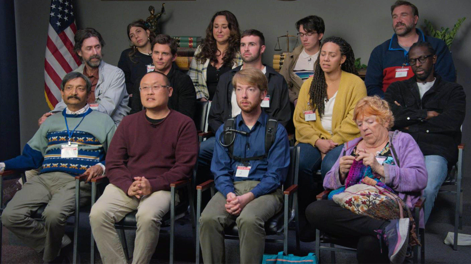 The cast of Jury Duty sitting in three rows. 