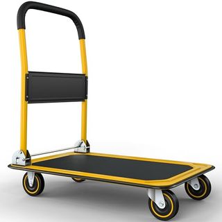 A black and yellow metal moving dolly with four wheels and a flat bed base. 