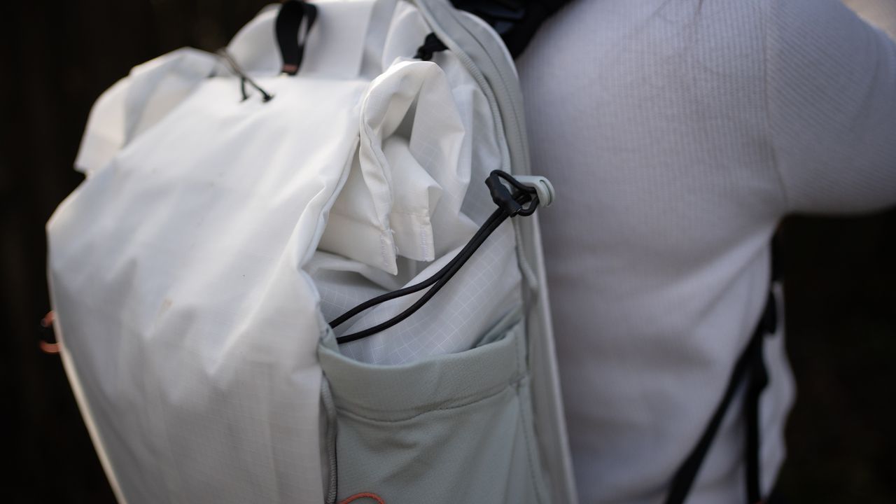 woman wearing the peak design outdoor bag in a nature reserve