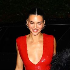 Kendall Jenner wears a glittering red Chanel dress with a black fur coat