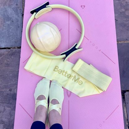 BetterMe review: Georgia's feet on her workout mat with her BetterMe resistance band, Pilates ball and Pilates ring