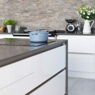 kitchen room with grey wall and kitchen worktops