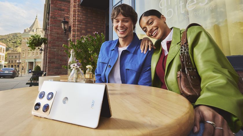 A man and woman looking at the Motorola Razr Fold