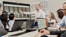 Whitepaper on Generative AI and ML for the enterprise, with image of colleagues in a conference room with latops and presentation screen