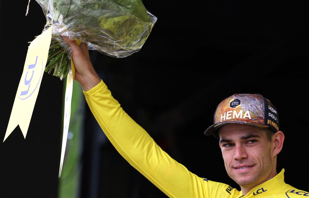 JumboVisma teams Belgian rider Wout Van Aert celebrates with the overall leaders yellow jersey on the podium after the 3rd stage of the 109th edition of the Tour de France cycling race 182 km between Vejle and Sonderborg in Denmark on July 3 2022 Photo by Thomas SAMSON AFP Photo by THOMAS SAMSONAFP via Getty Images
