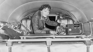 Amelia Earhart checking equipment on her airplane, circa 1937.