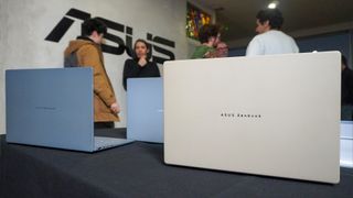 Several Asus Zenbook A14 laptops on a table at CES 2025