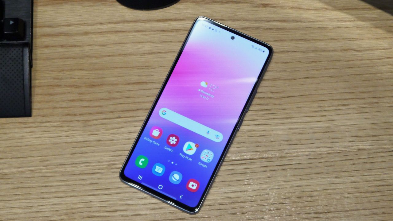 Samsung Galaxy A53 5G laid on a wooden desk, with its screen on