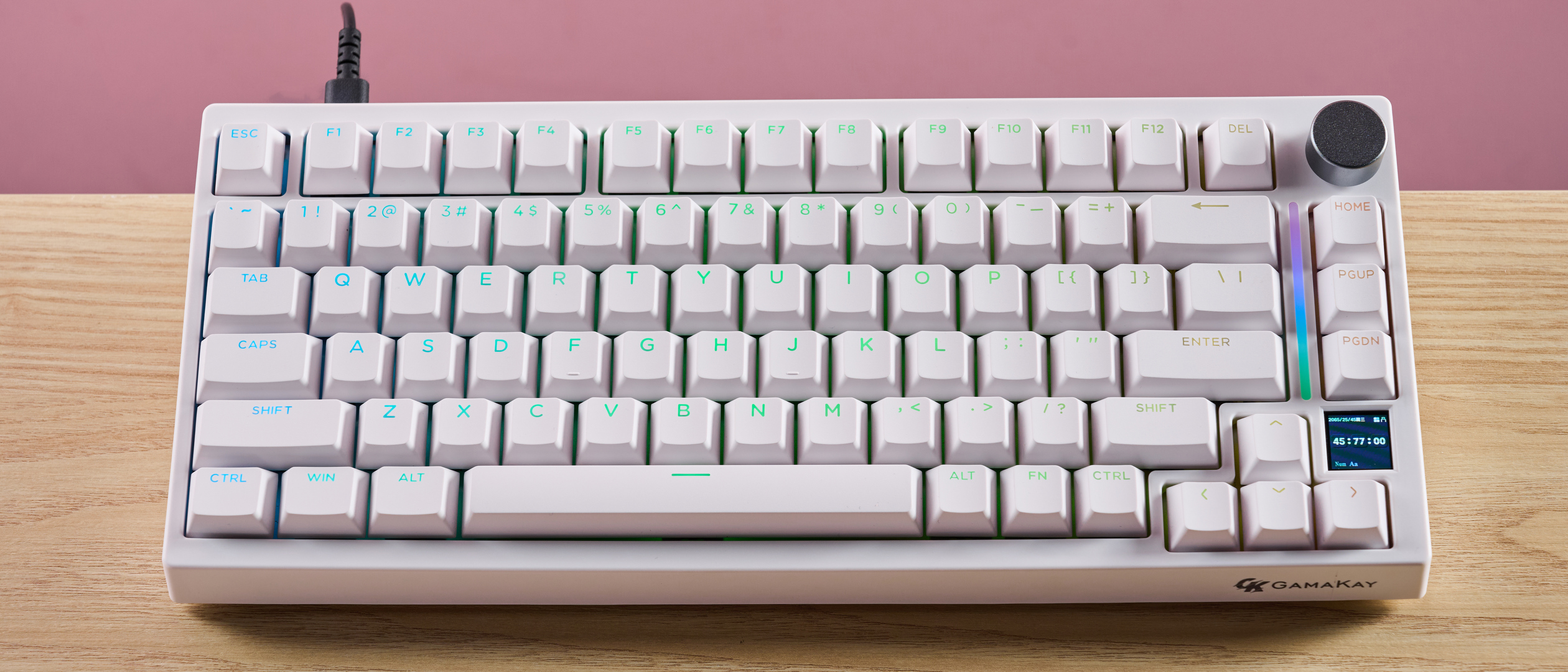 Gamakay TK75HE V2 on desk with pink wall in background