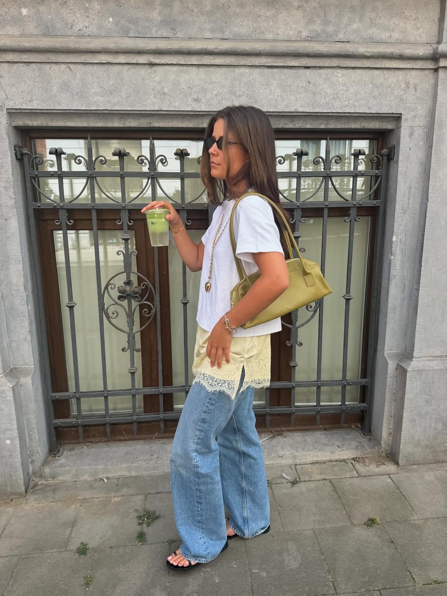 Woman in t-shirt, butter yellow lace dress and jeans