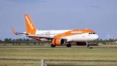 EasyJet plane landing on a runway in Amsterdam