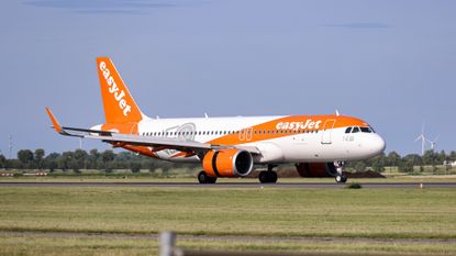 EasyJet plane landing on a runway in Amsterdam