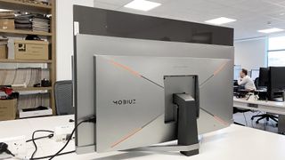 BenQ Mobiuz EX480UZ from behind, showing the build quality and orange accents