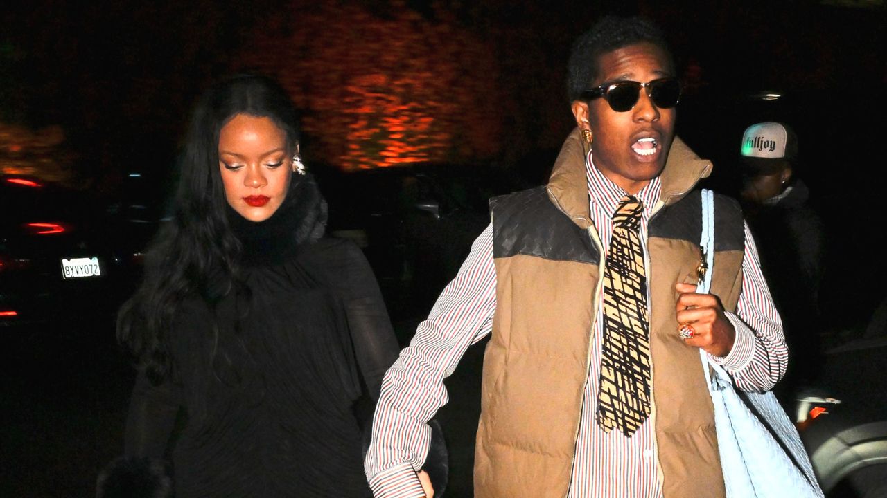 Rihanna and A$AP Rocky holding hands while he carries a bottega bag