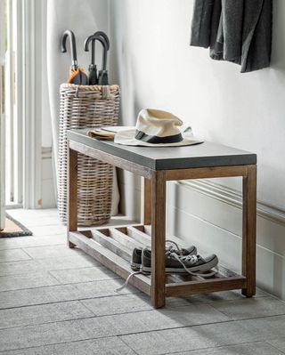Small boot room storage solution with bench and umbrella stand