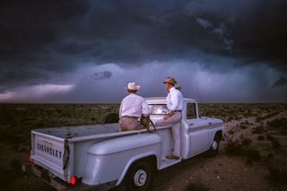 Photograph of two men in a Chevrolet pickup truck by Paul Fusco, New Mexico, USA, 1963