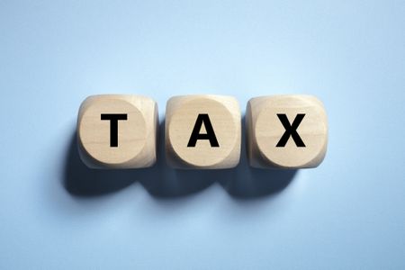 the word tax spelled out on wooden cubes