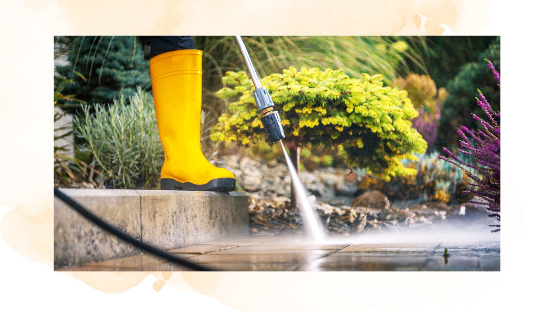 picture of person pressure washing their garden patio with yellow boots on
