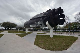 Space Center Houston is the first museum to exhibit a flight-proven SpaceX Falcon 9 rocket stage. Visitors can walk under the booster, which is mounted 14 feet (4 meters) above the ground.