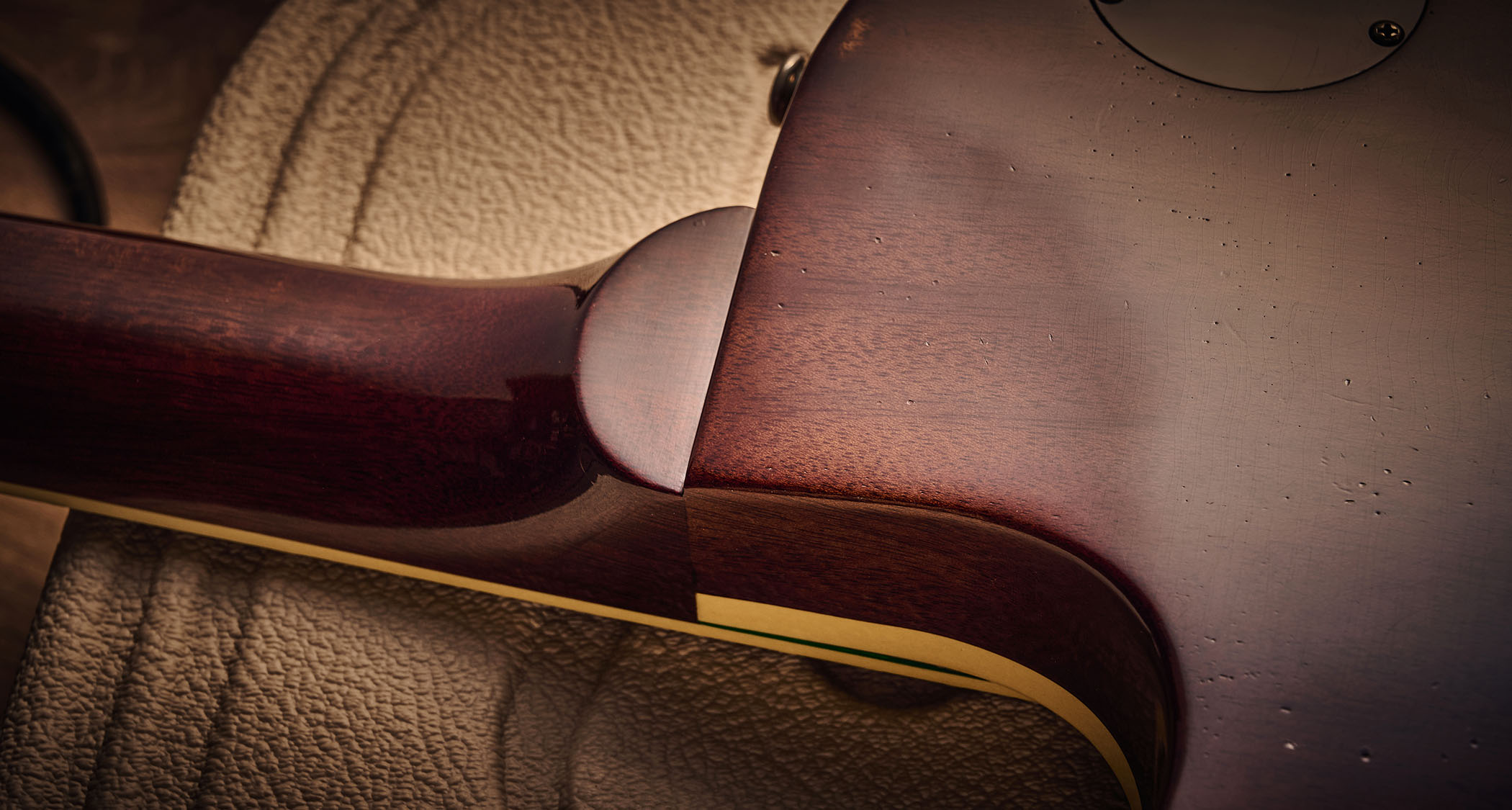 Ivison Dakota Standard in Cadillac Green photographed against its cream-covered Hiscox hard-shell guitar case.